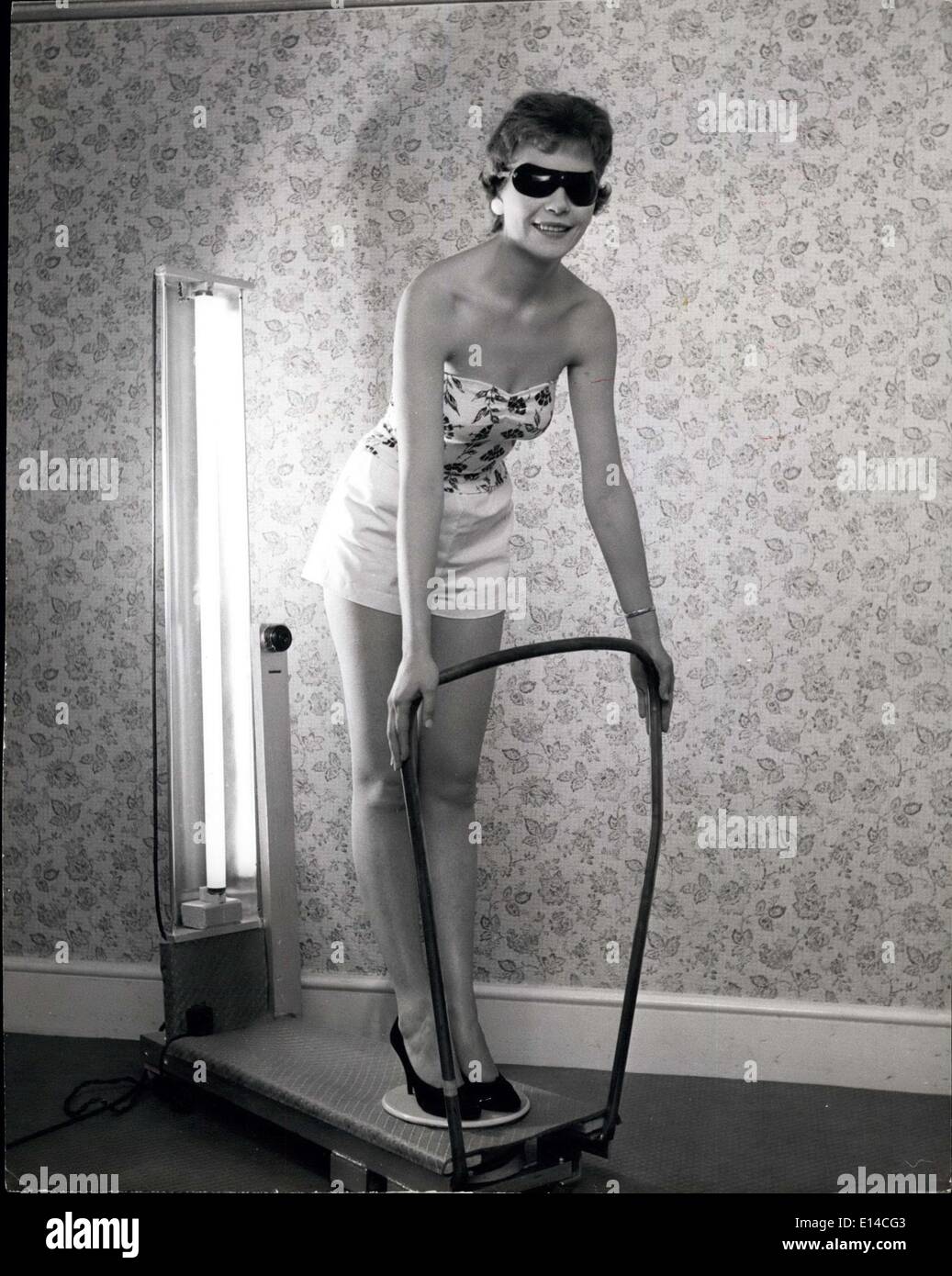 Apr. 17, 2012 - e ora il retro: 21-anno-vecchio abbigliamento impresa modello di Sylvia Smith,ali regina durante la Battaglia di Bretagna settimana nel 1957 e 1959, ottiene il suo shilingsworth di sole. Inverno Tan: Sunshine da una slot machine: Due minuti di tonici di sole alimentato da una slot machine a un danaro un tempo, provvederà a riportare che ''Summer abbattimento'' per le donne e gli uomini che ottenere ''sotto il meteo''questo inverno.Mr.James Morgan, 57-anno-vecchio fisioterapista da Leighton Buzzard, Beds, ha realizzato il prototipo con un giro di tavola che trasforma il cliente come un pollo allo spiedo davanti ad un ultra-violetta tubo radiogeno Foto Stock