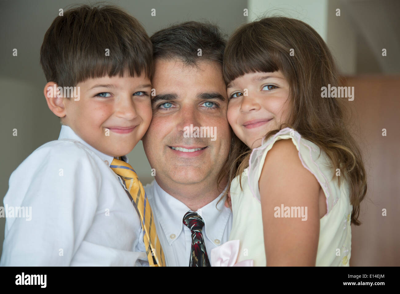 Caucasian padre e figli sorridente in usura formale Foto Stock