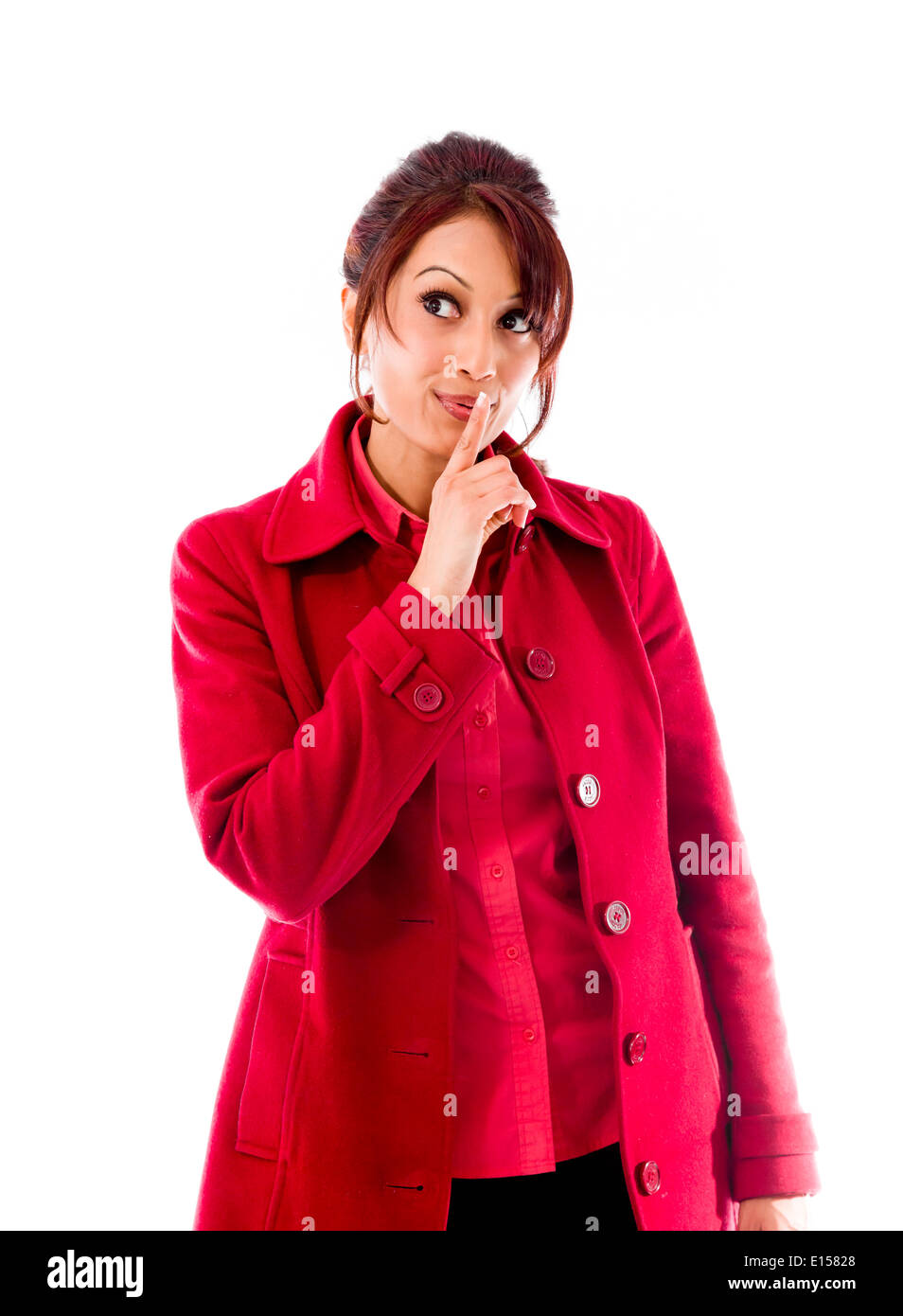 Indian giovane donna in piedi con il dito sulle labbra Foto Stock