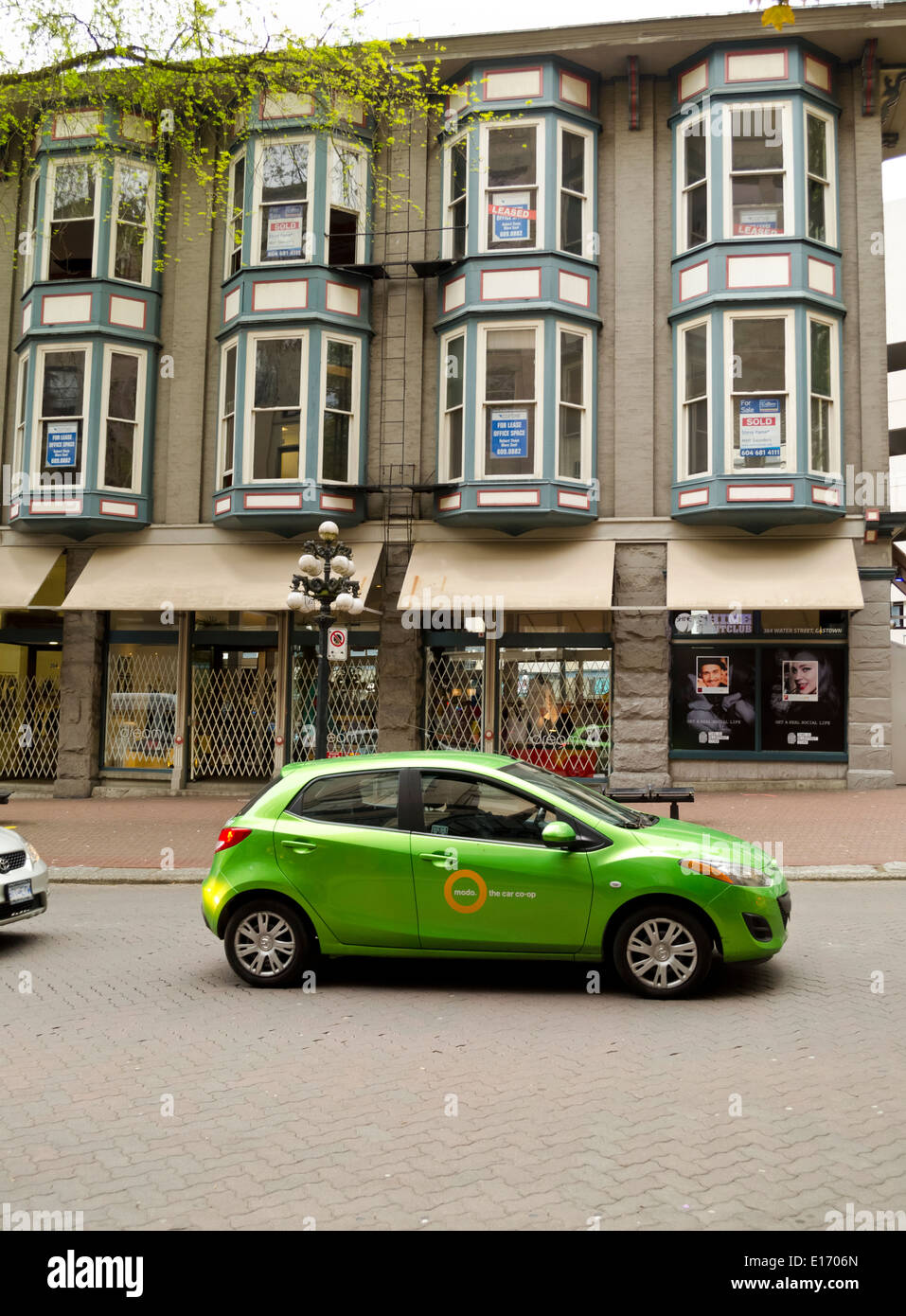 Un 'modo' auto car-sharing a Vancouver in Canada. Per le strade del centro storico Gastown Vancouver. Edifici storici e negozi. Foto Stock