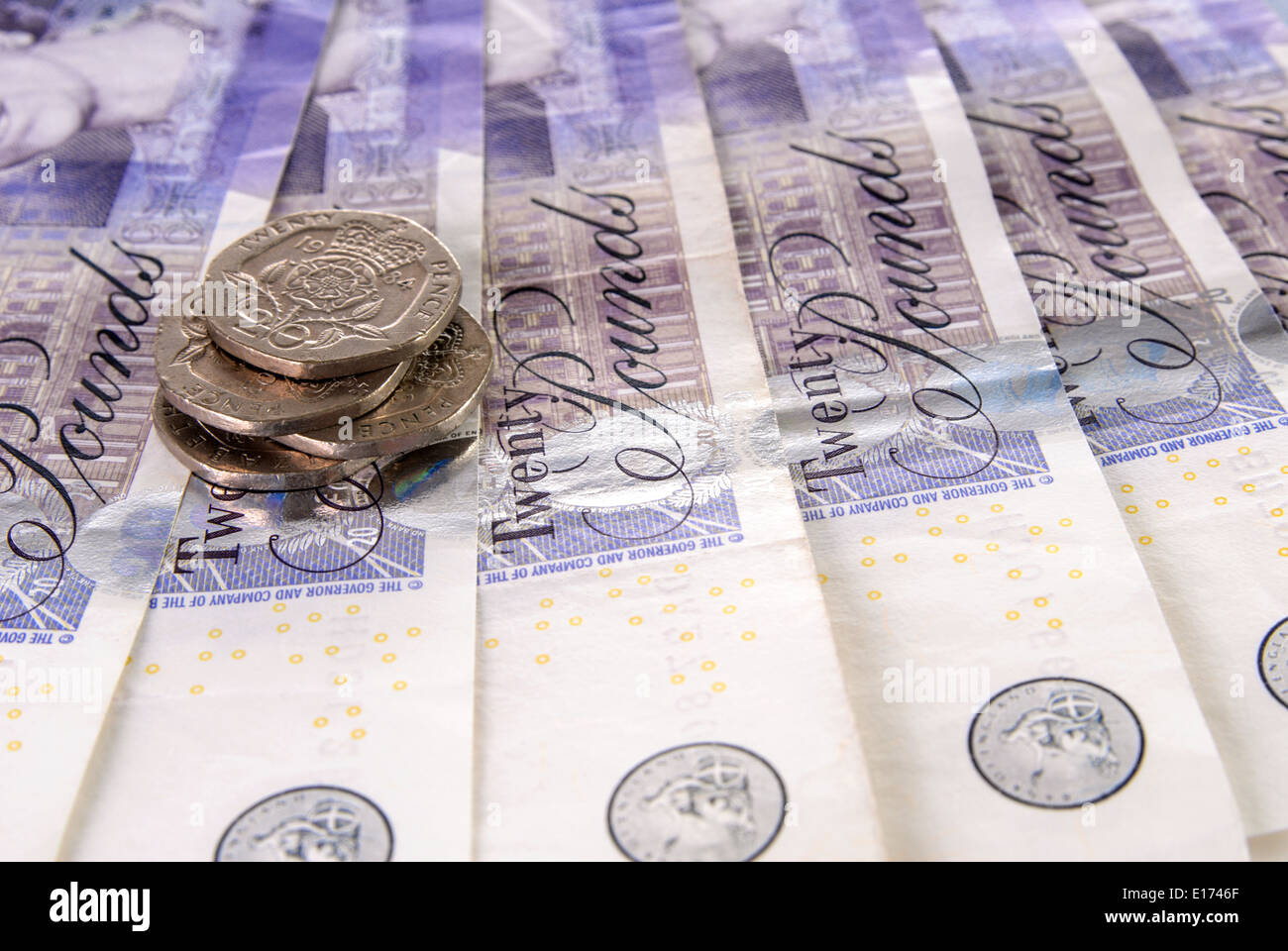 British Pound Note e pila di monete Foto Stock