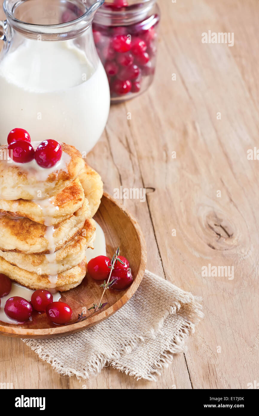 Russo frittelle di quark con latte condensato e cranberry. Messa a fuoco selettiva. Copia di sfondo spazio. Foto Stock