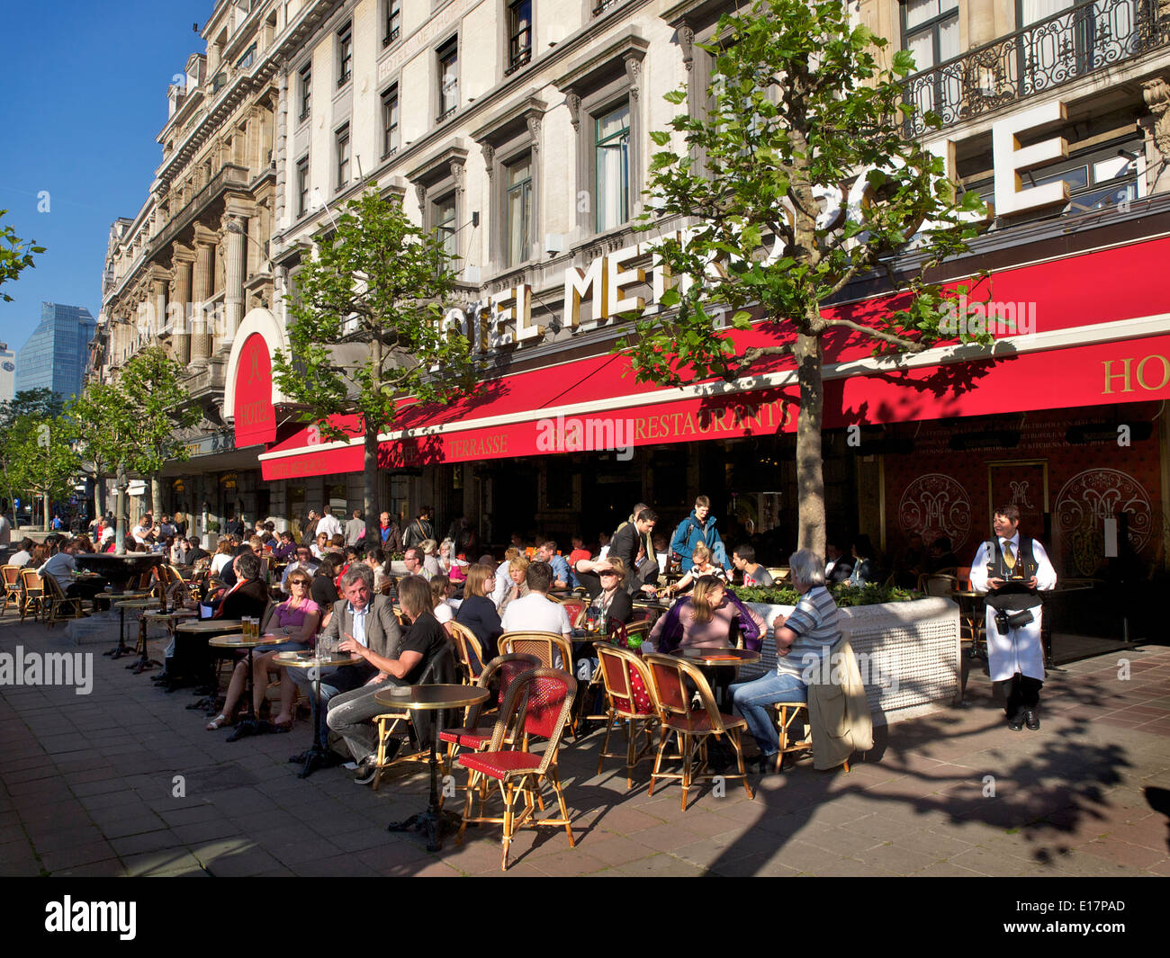 Le persone che si godono il sole pomeridiano di fronte al famoso Hotel Metropole a Bruxelles, in Belgio Foto Stock
