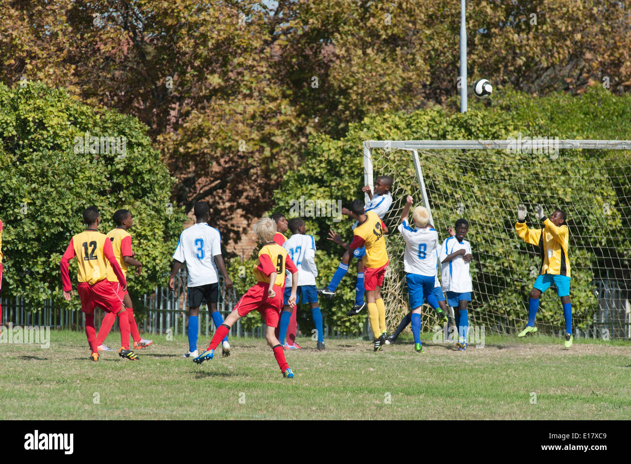 Junior football giocatori nella zona di obiettivo dopo un calcio d'angolo, Cape Town, Sud Africa Foto Stock