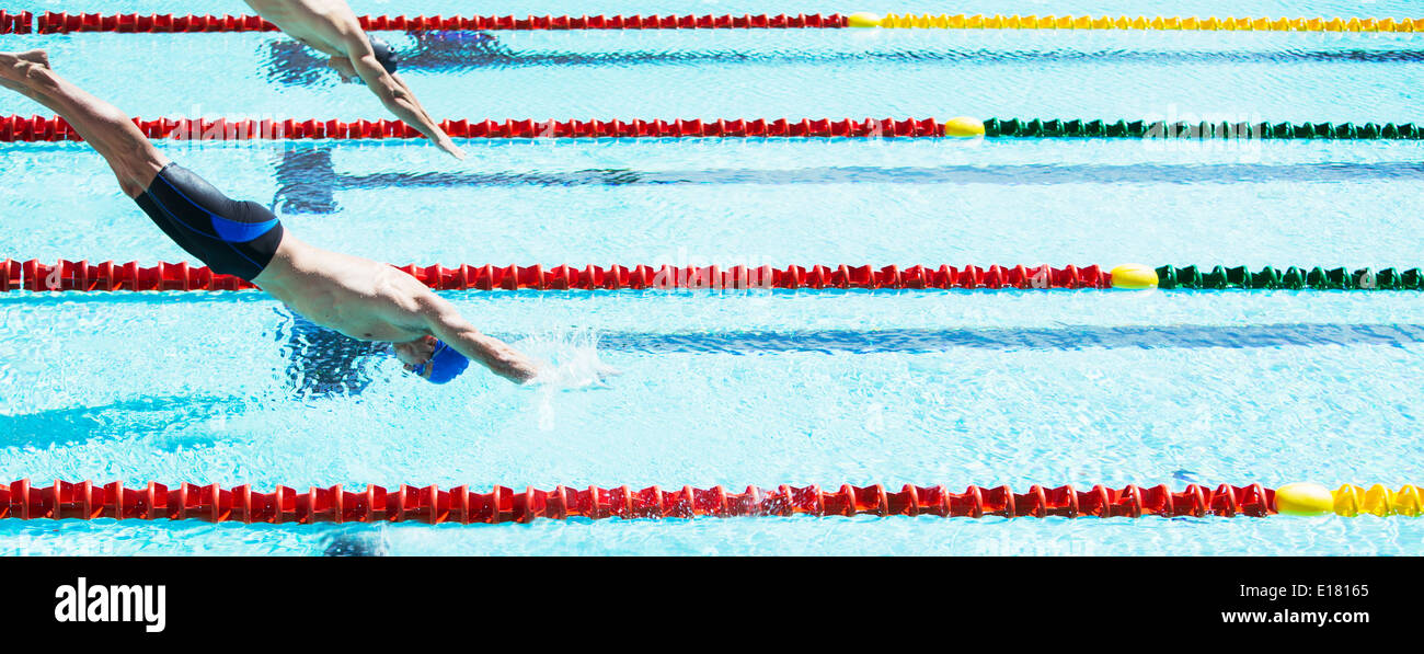 Nuotatori tuffarsi in piscina Foto Stock