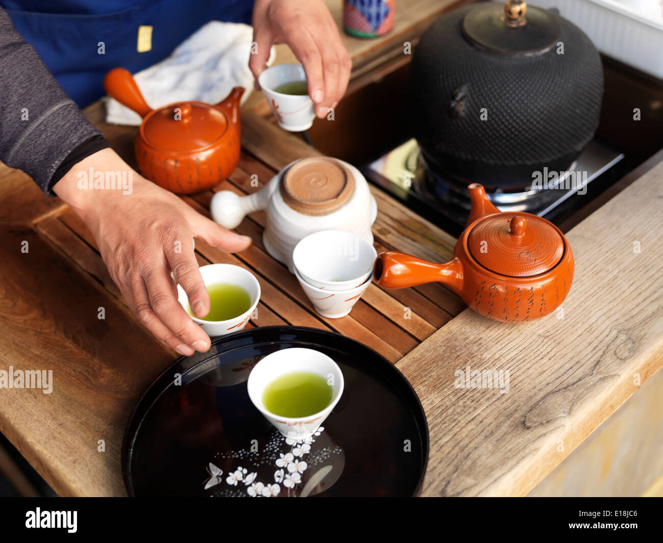 Persona che offre il tè matcha campioni su strada a Tokyo in Giappone. Foto Stock
