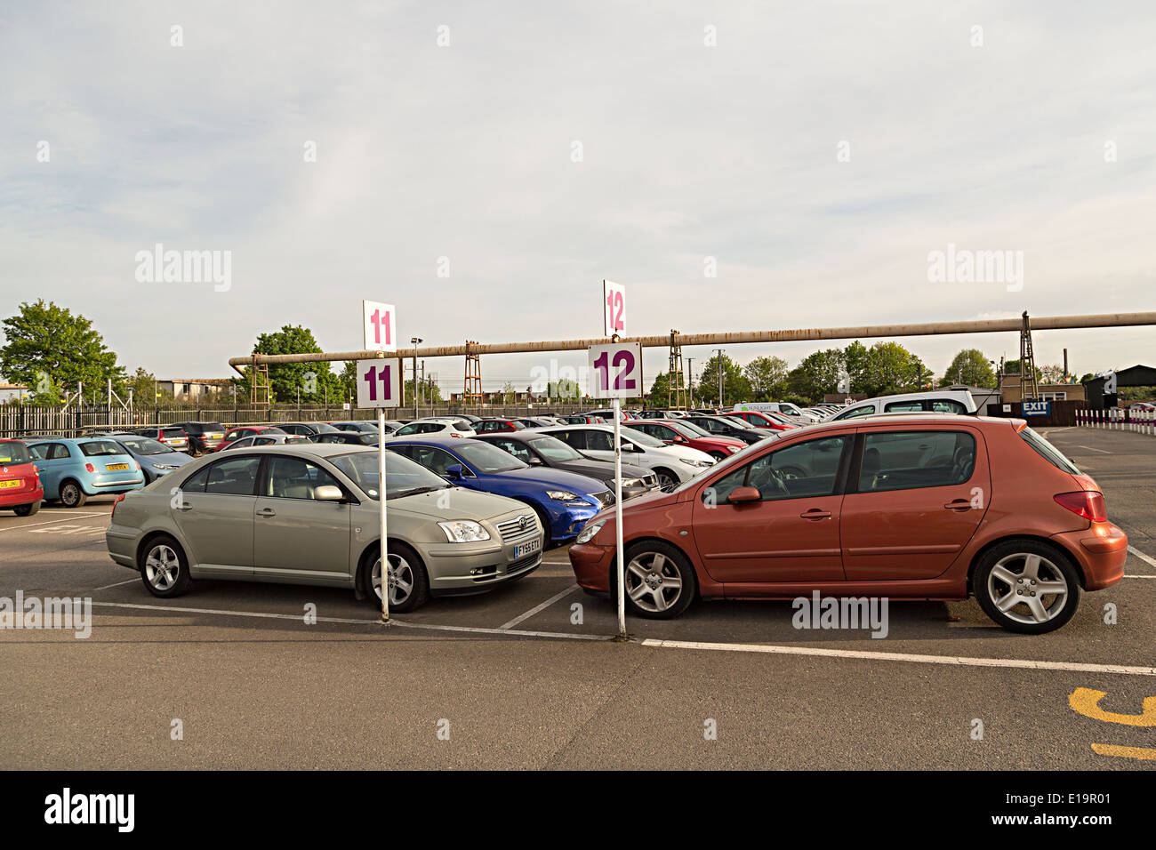 Auto parcheggiate in righe numerate al parcheggio fuori sede per l'aeroporto di Heathrow di Londra, Regno Unito Foto Stock