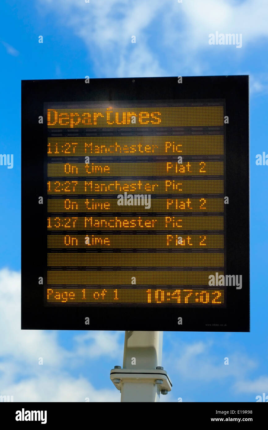 Electronic treno Partenze scheda contro un cielo blu England Regno Unito Foto Stock