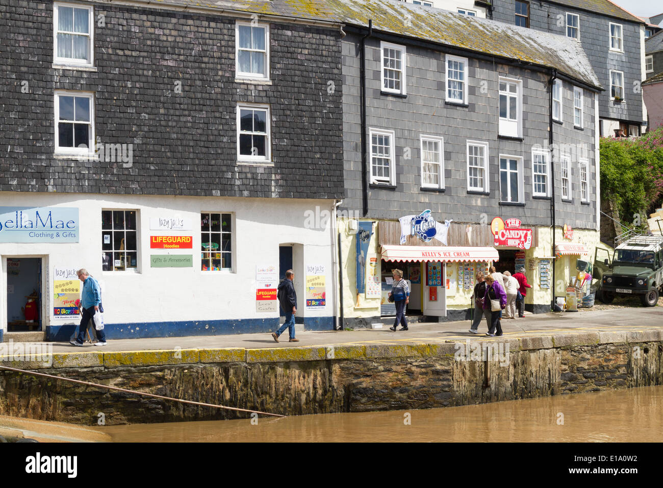 Negozi, pub e caffetterie intorno al porto di Mevagissey in Cornovaglia Foto Stock