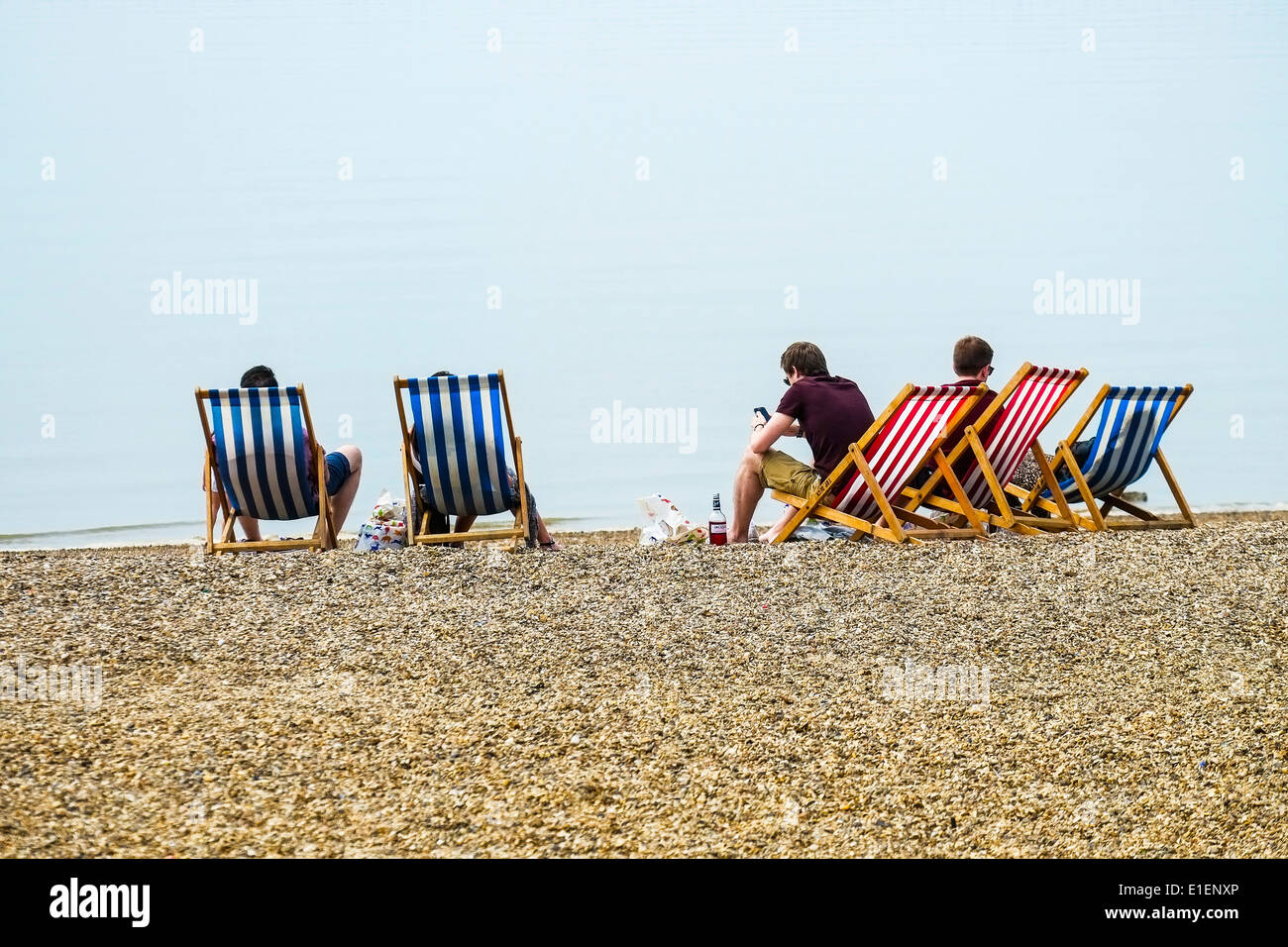 Persone in rilassanti sedie a sdraio sulla spiaggia del Giubileo a Southend on Sea. Foto Stock