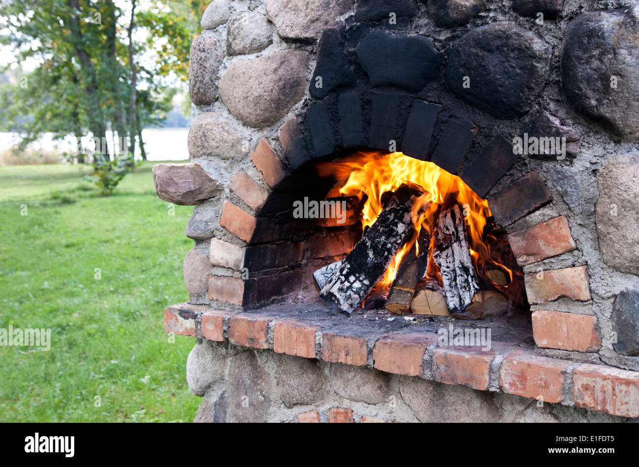 Fermo barbecue camino con la combustione di legna al giorno di estate Foto  stock - Alamy