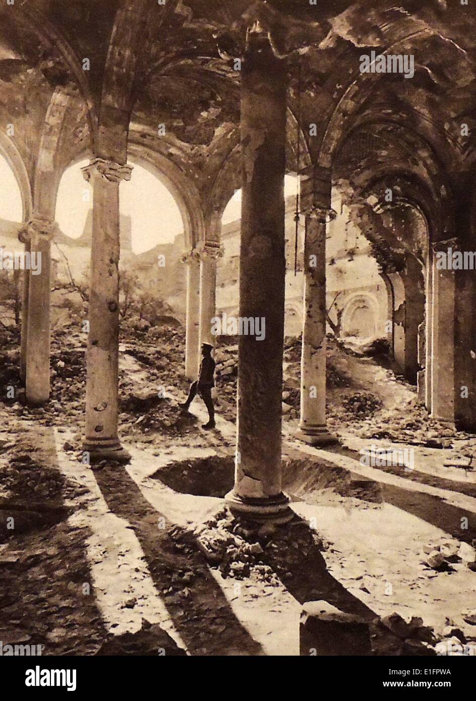 Fotografia scattata a seguito dei bombardamenti durante la guerra mondiale I. Un soldato si erge all'interno resti del Chiostro della Cattedrale di Arras, Francia. Datata 1919 Foto Stock