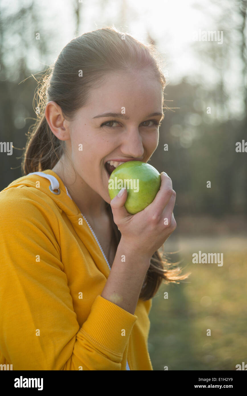 Ritratto di giovane donna runner mangiando un Apple Foto Stock