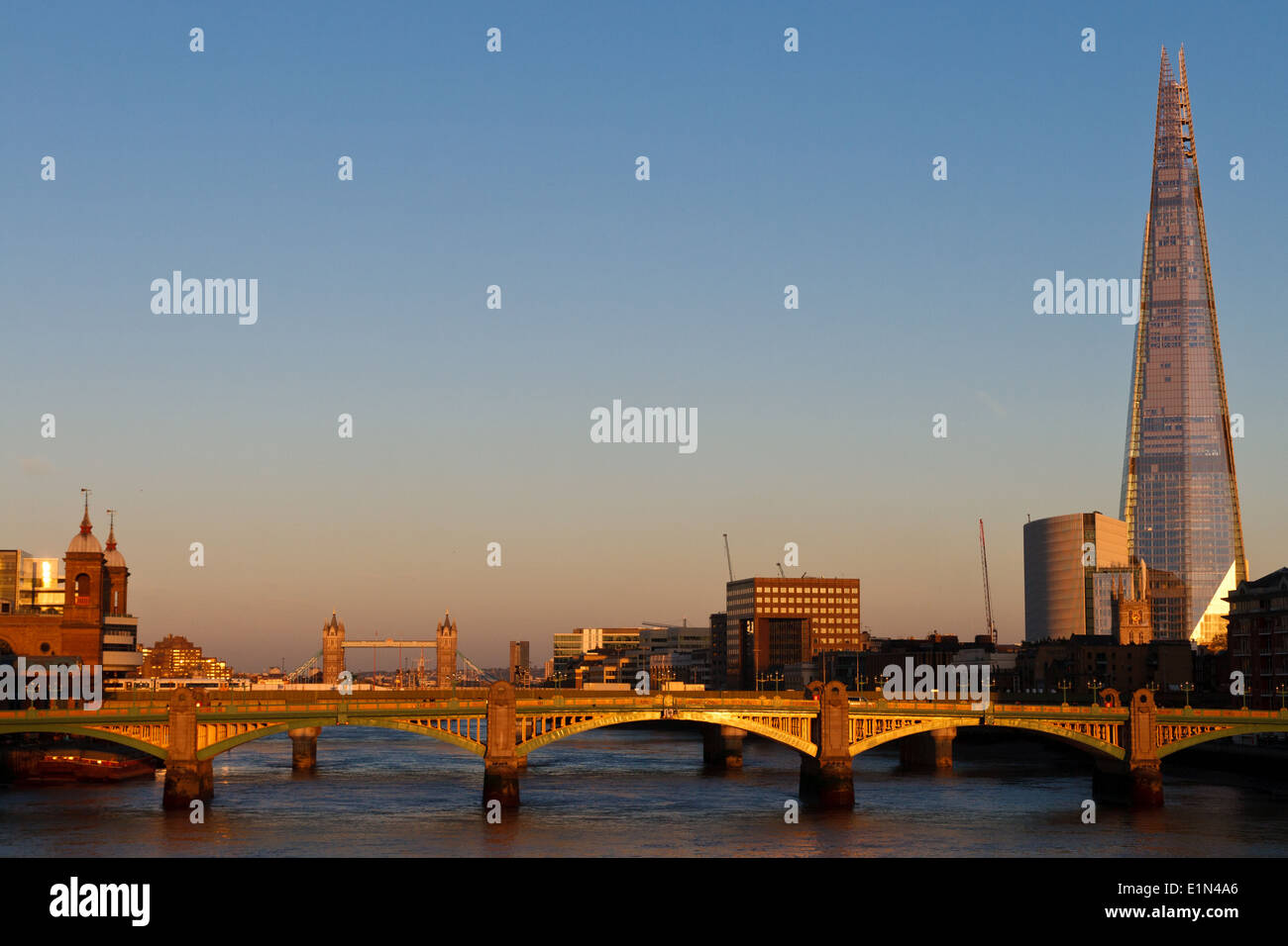 Vista del Shard, Southwark Bridge e il Tower Bridge, raccolti nella luce dorata al tramonto. Foto Stock