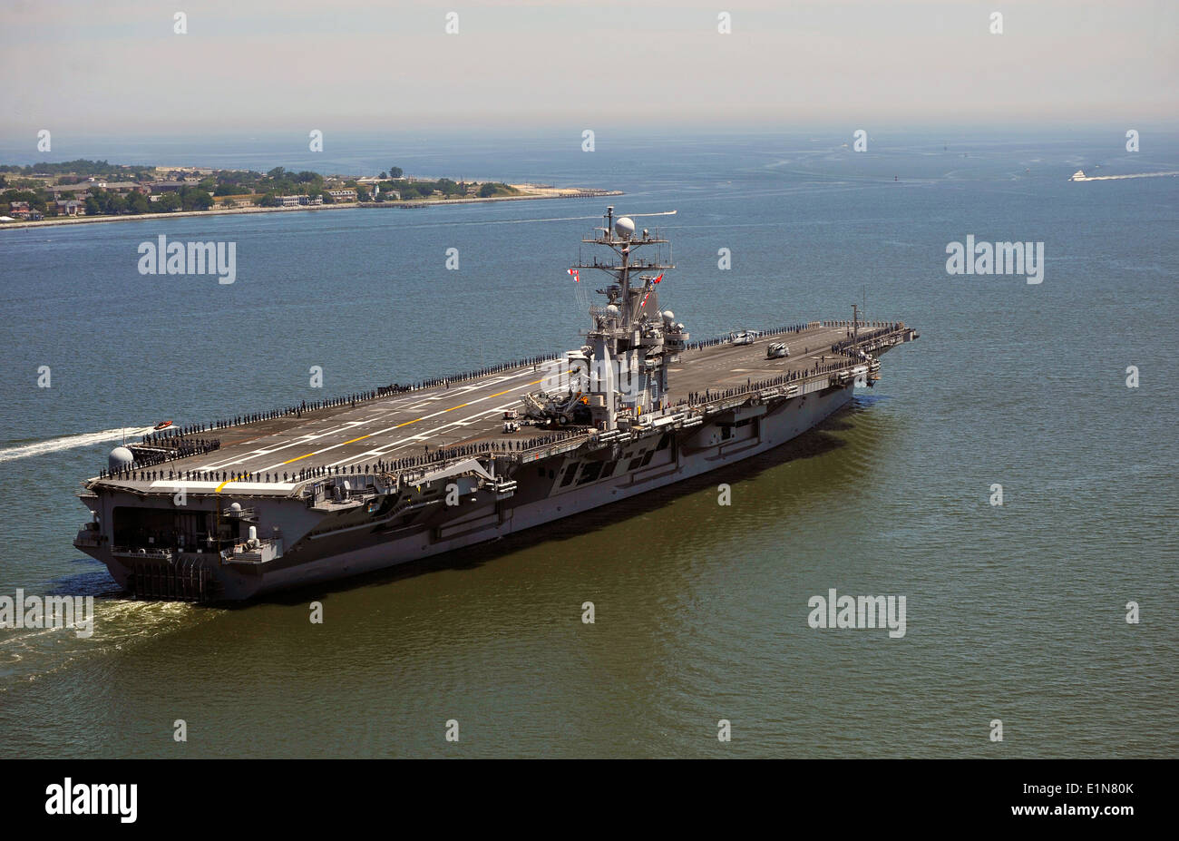 US Navy marinai e Marines uomo le rotaie a bordo della Nimitz-class portaerei USS Harry Truman come la nave parte per una distribuzione programmata 21 Maggio 2010 da Norfolk, Virginia. Foto Stock