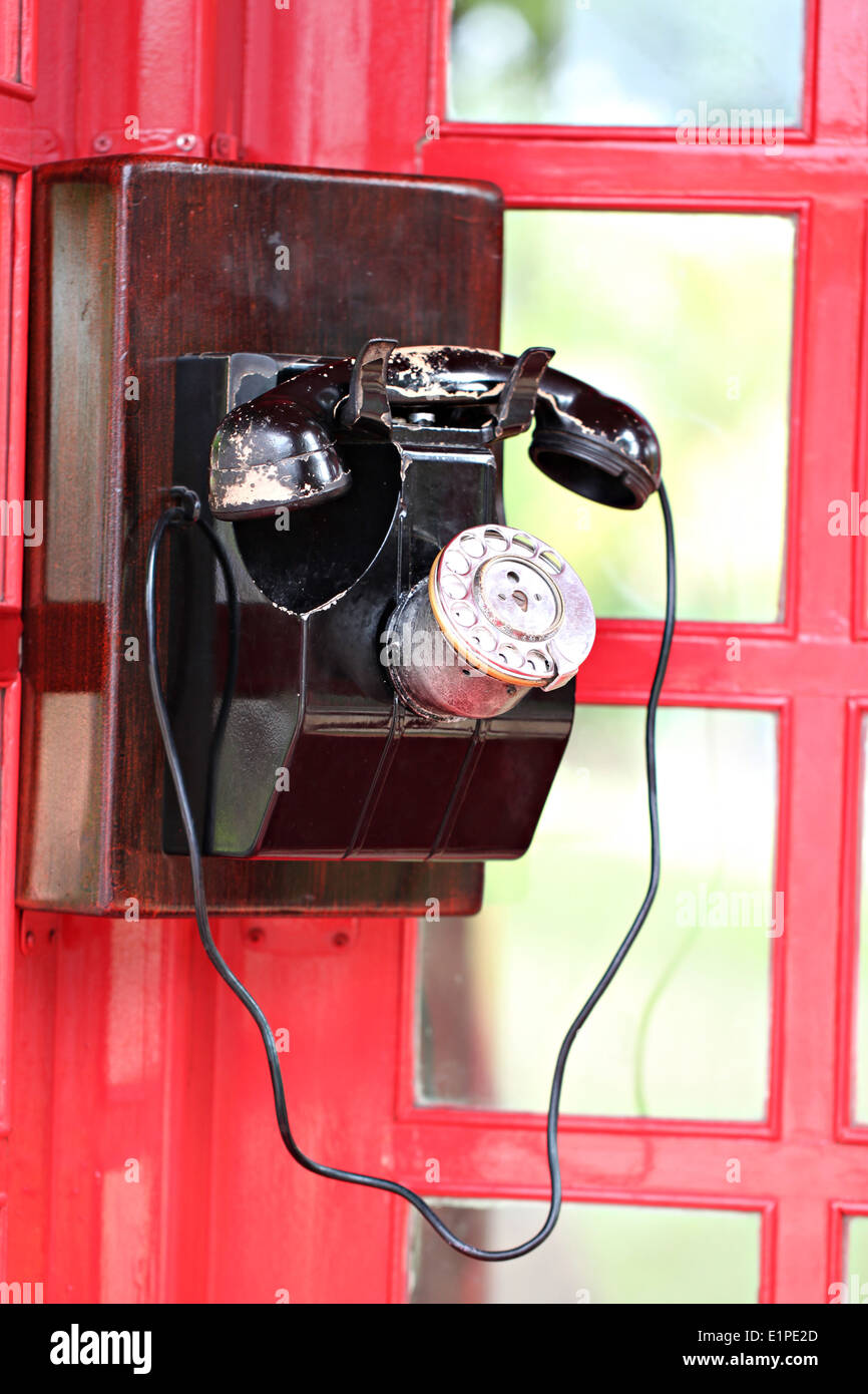 Retrò in metallo di colore nero antico telefono rosso nella casella Telefono. Foto Stock