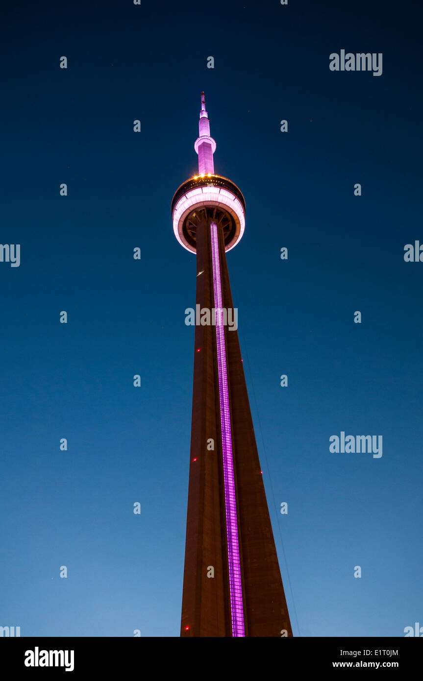 Dettaglio della CN Tower con violette luci nel centro cittadino di Toronto al crepuscolo Foto Stock