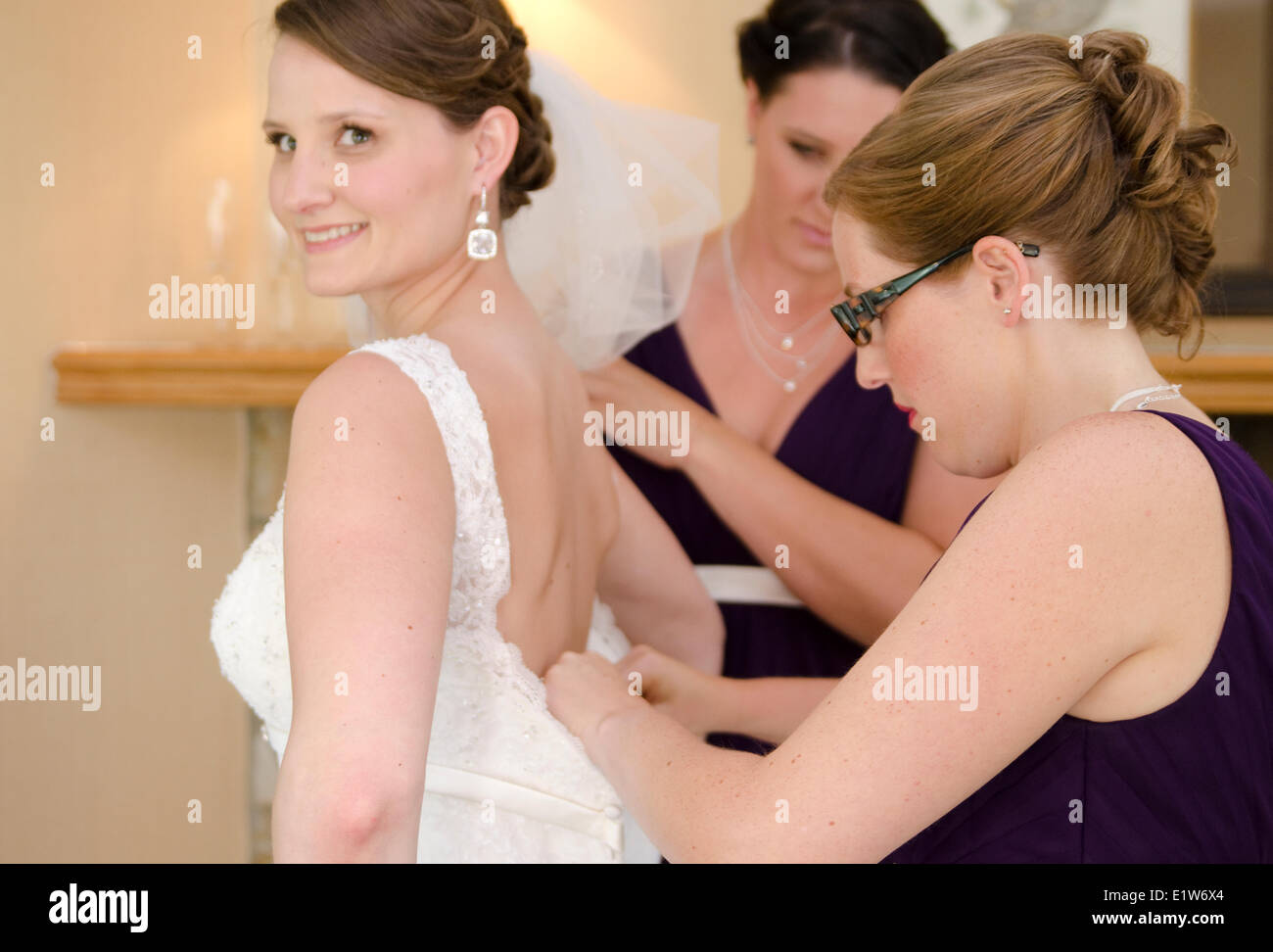 Bridesmaids aiutare promessa sposa a prepararsi per il suo matrimonio al Fairmont Jasper Park Lodge, Jasper, Alberta, Canada Foto Stock
