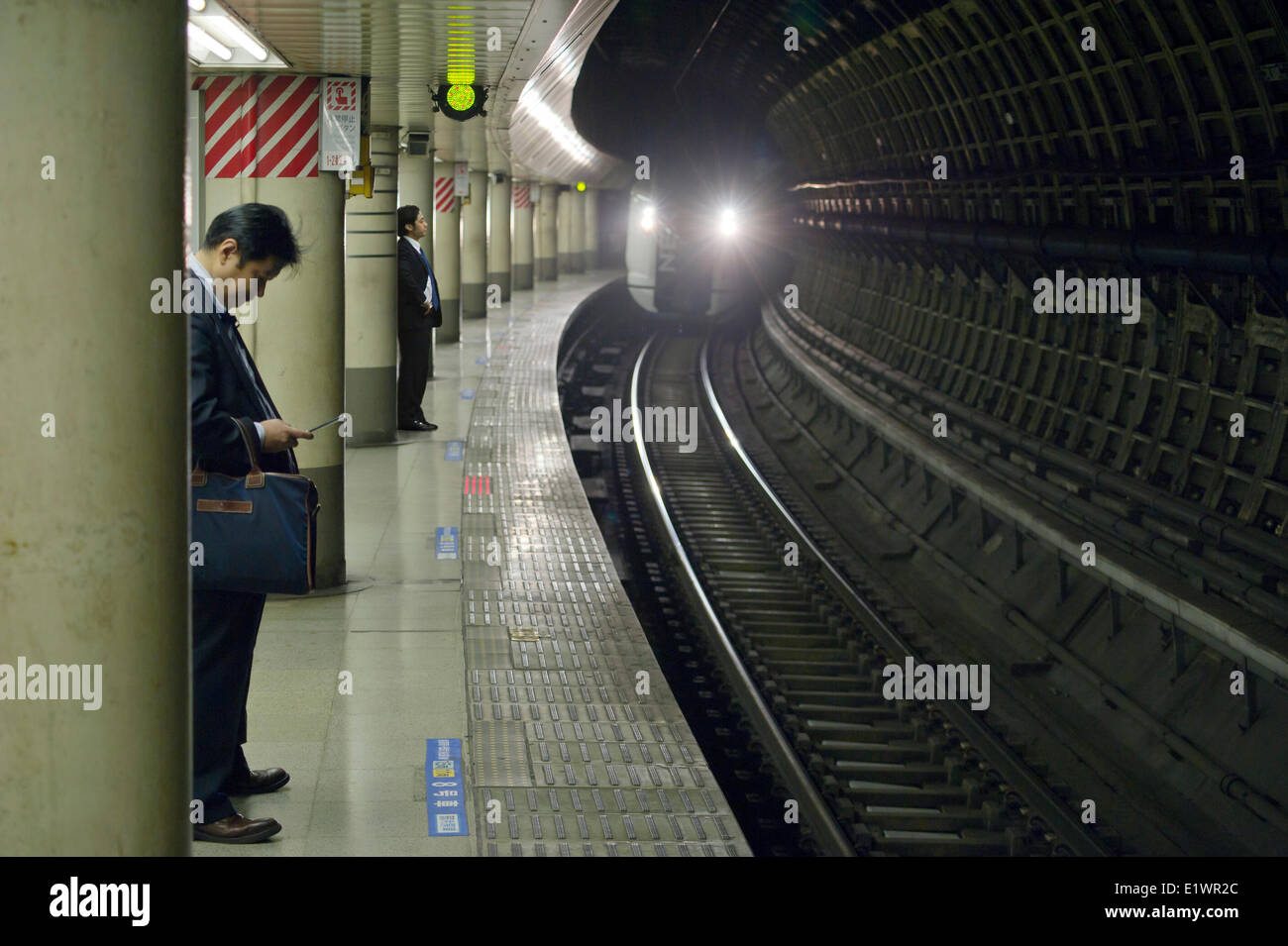 In treno arrivando a una piattaforma a Tokyo Foto Stock