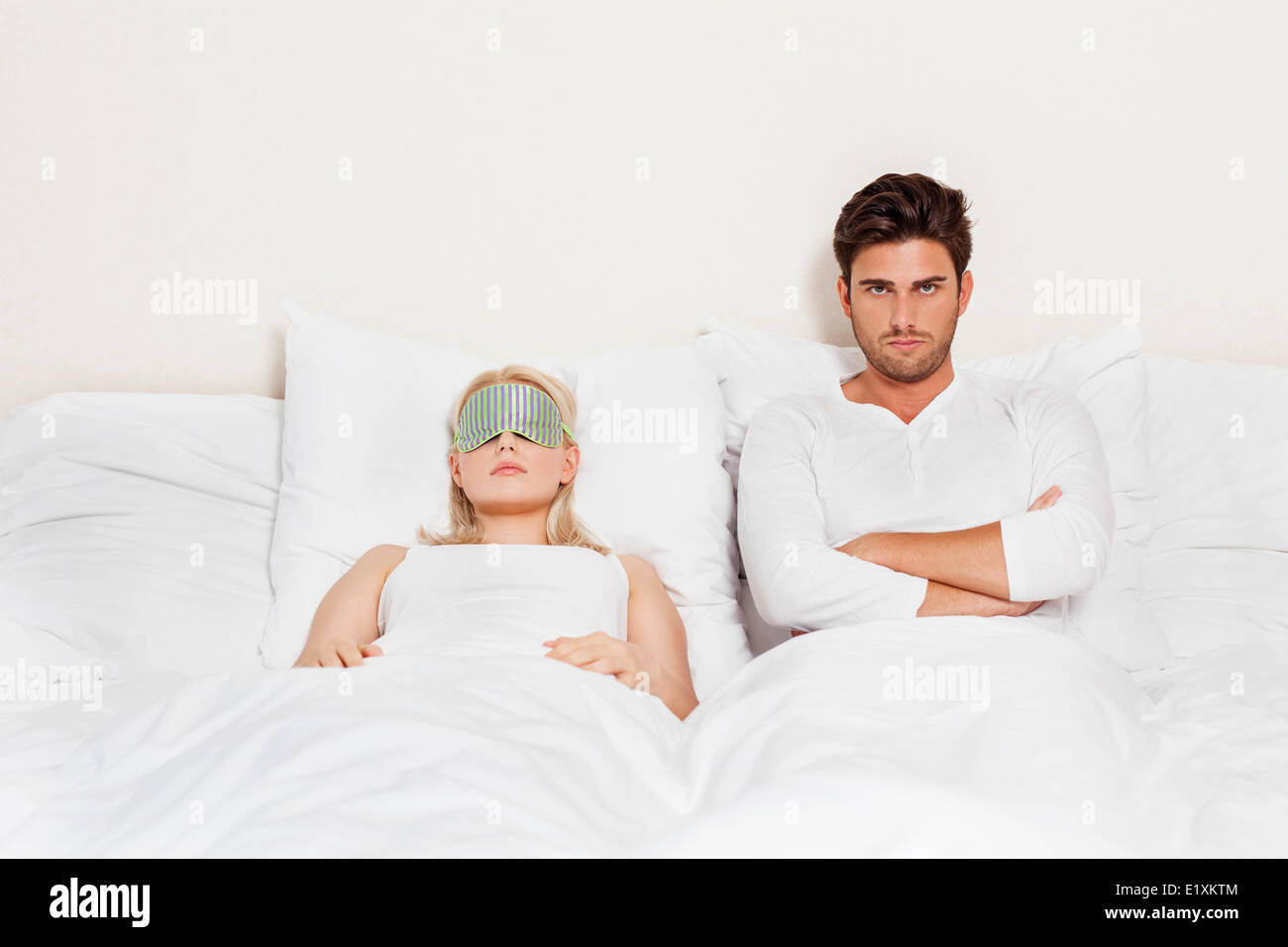 Ritratto di dispiacque all uomo con la donna che dorme nel letto Foto Stock