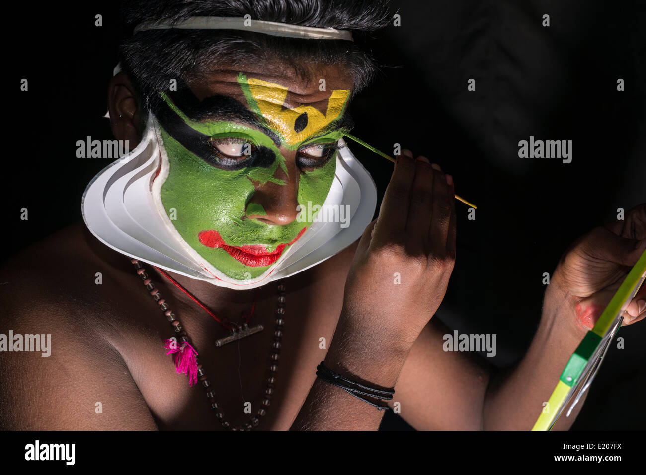 Un artista Katakali sta applicando il make-up del carattere Arjun per la Santhana Gopalam riproduzione durante un festival tempio, Ayroor Foto Stock
