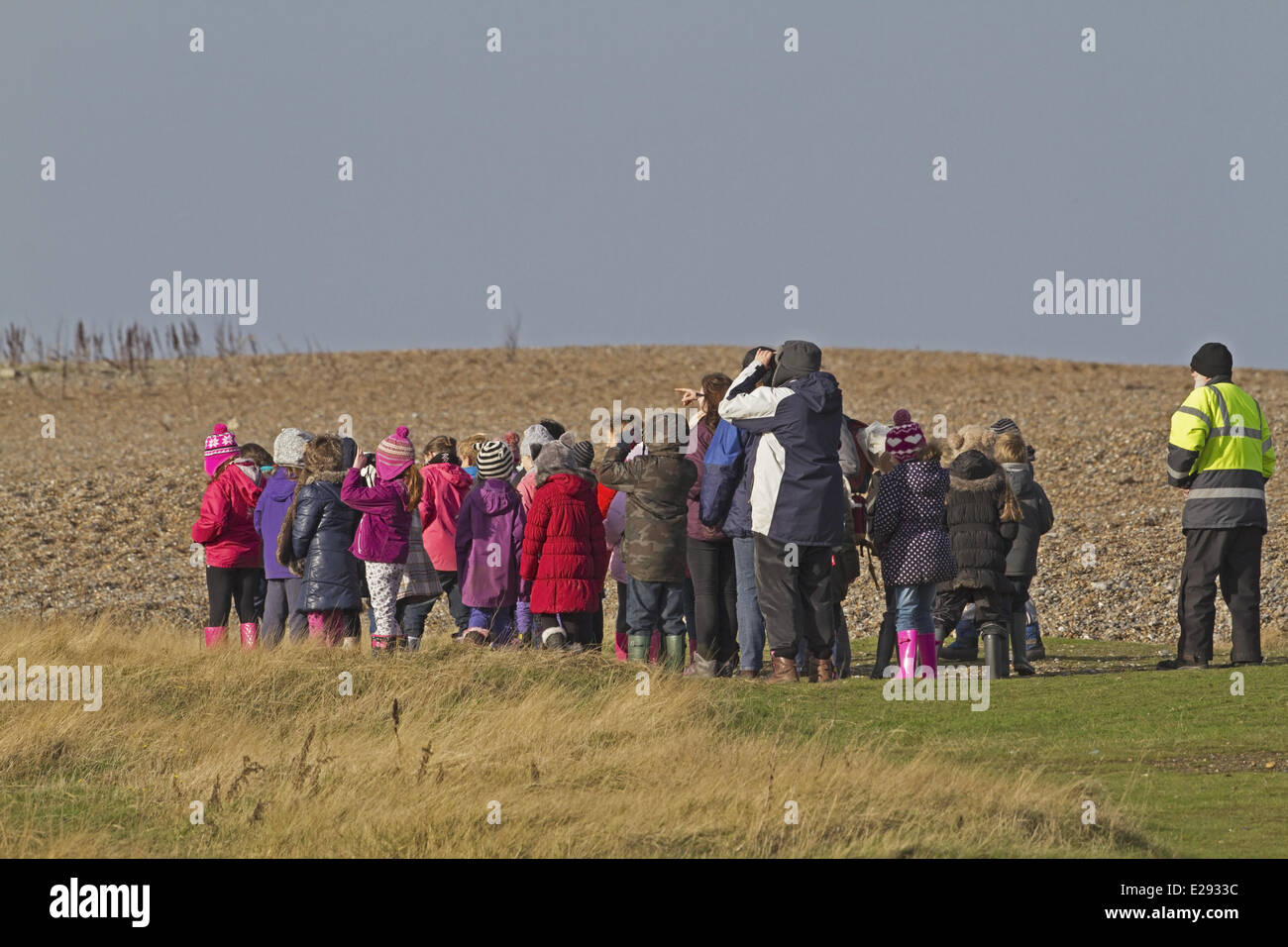 Gruppo scolastico di birdwatching sul litorale, Norfolk, Inghilterra, Novembre Foto Stock