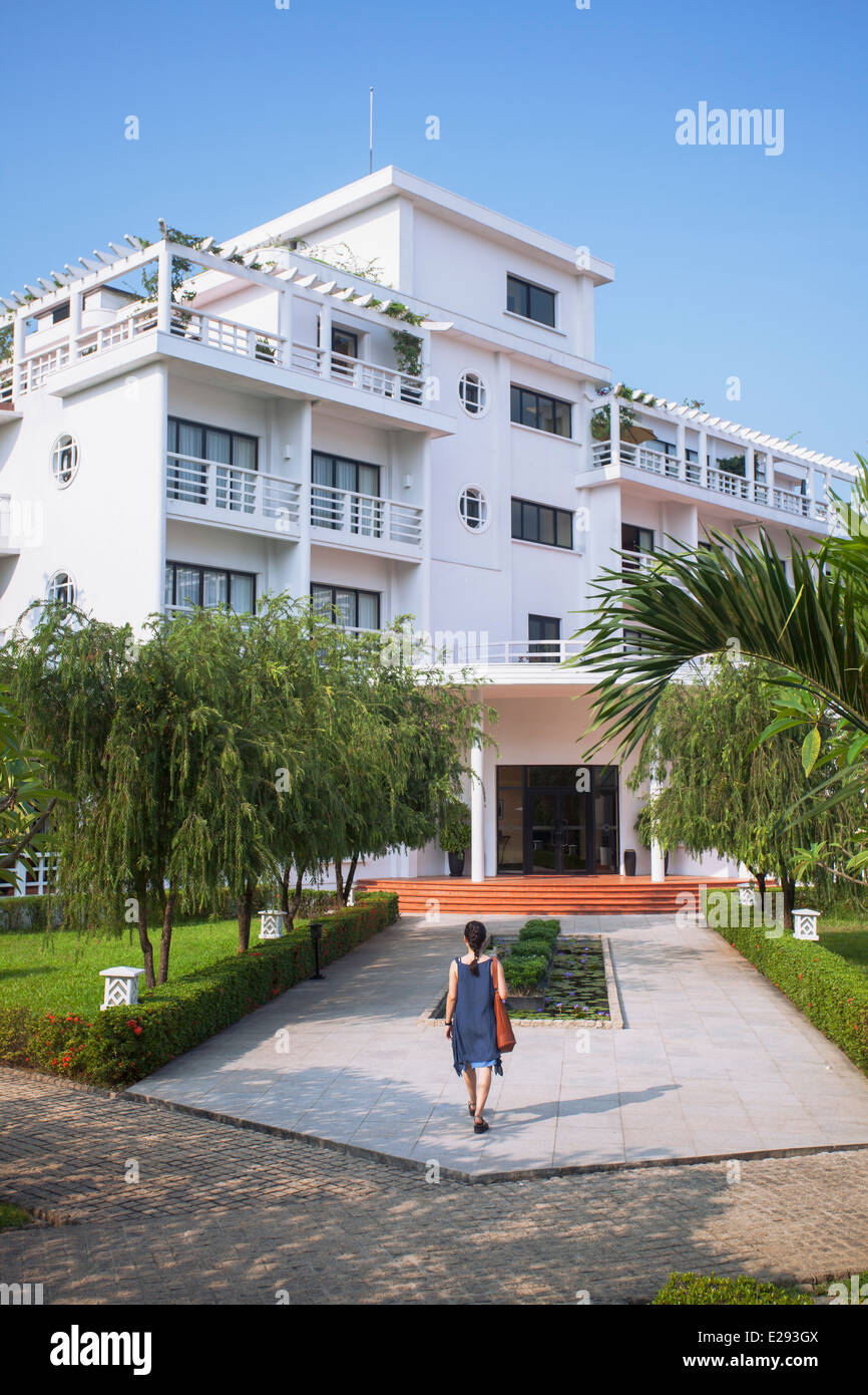 Donna che cammina in motivi di La Residence Hotel, tonalità, Thua Thien-Hue, Vietnam Foto Stock