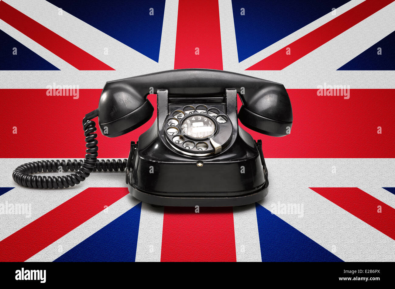 Office: vecchi e vintage telefono sulla bandiera dell'union jack Foto Stock
