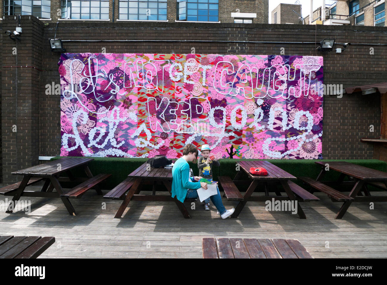 Tabellone a mano Arte di strada 'Cerchiamo di non restare impigliati Teniamoci andando' vicino a Brick Lane in Shoreditch London E2 KATHY DEWITT Foto Stock