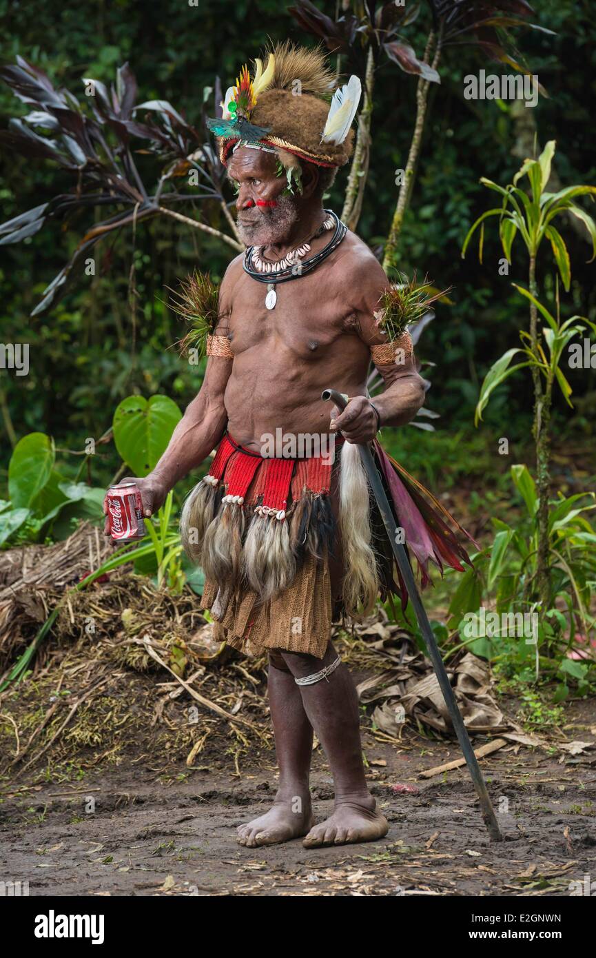 Papua Nuova Guinea Hela Regione Provincia di Tari village di Kobe Dumbiali Michael Mangope indossando il tradizionale abito Huli beve coca-cola Foto Stock