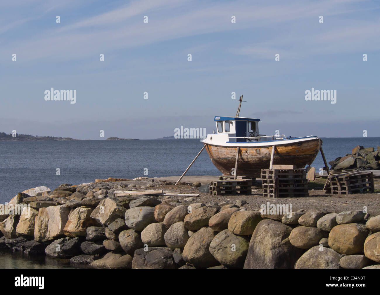 Costa del Mare del Nord vicino a Stavanger Norvegia, legno barca da pesca su un molo di pietra per la manutenzione Foto Stock