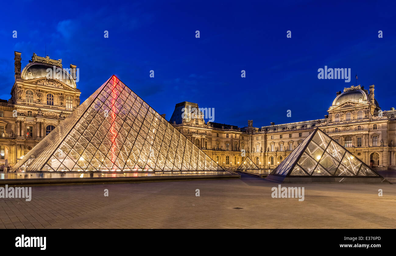 Il museo del Louvre di Parigi, al crepuscolo, una delle principali attrazioni turistiche in Francia e in Europa Foto Stock