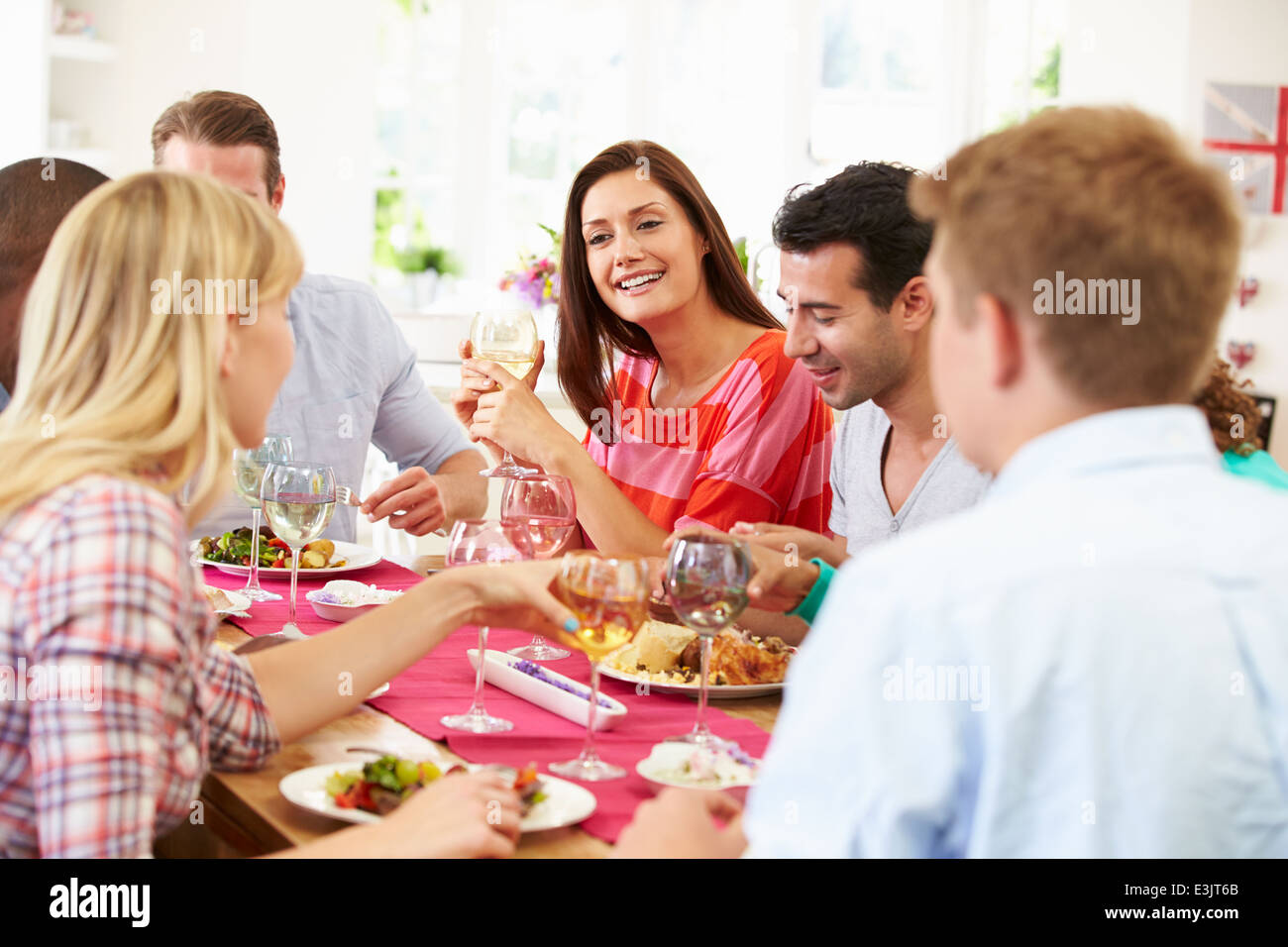 Gruppo di amici seduti attorno al tavolo con Cena Foto Stock