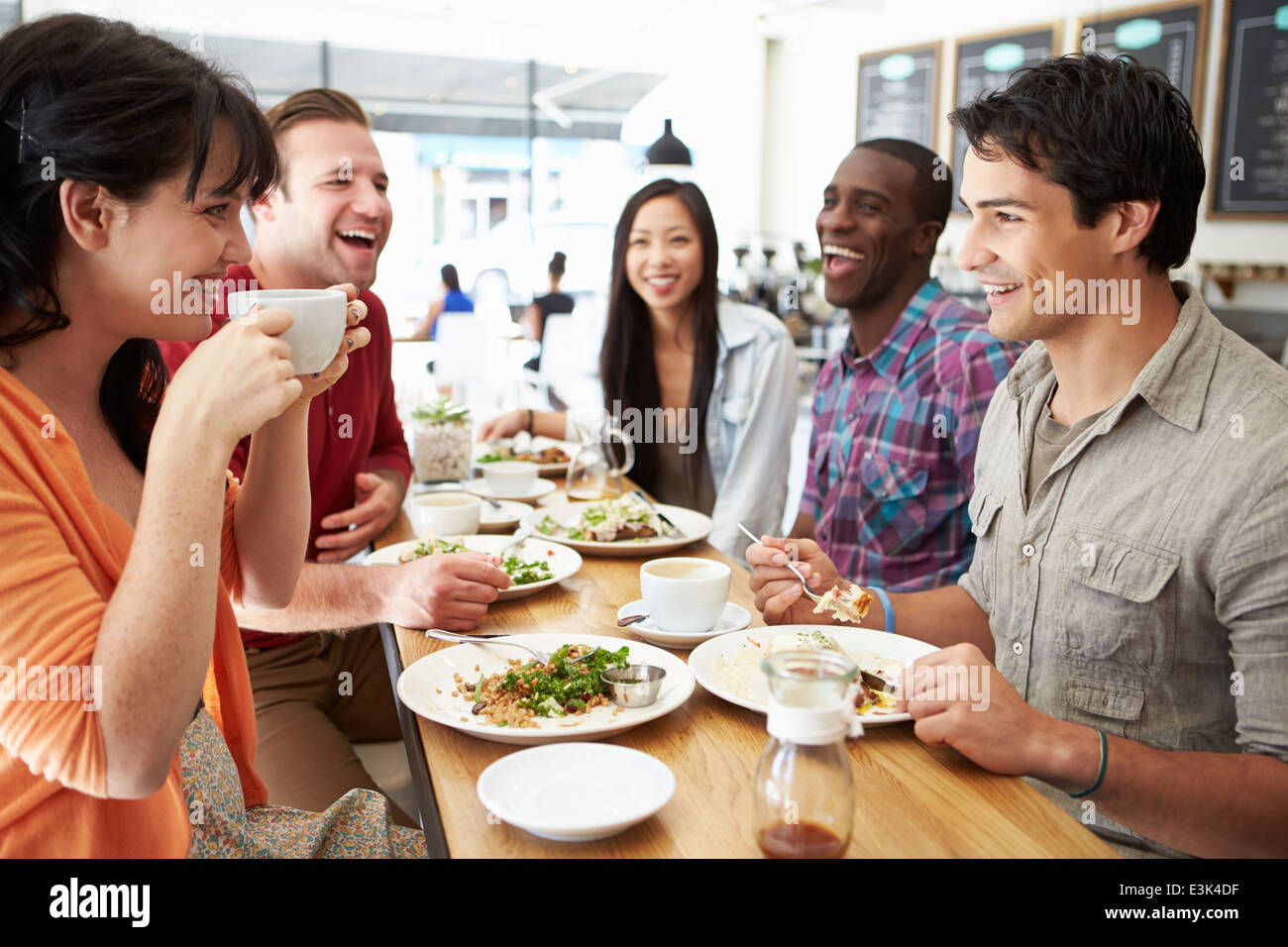 Gruppo di amici riuniti per il pranzo in un Coffee Shop Foto Stock