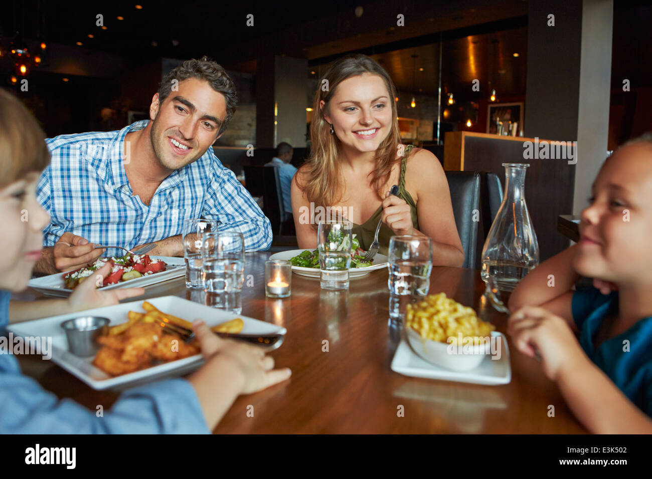 Famiglia godendo di pasto in ristorante Foto Stock