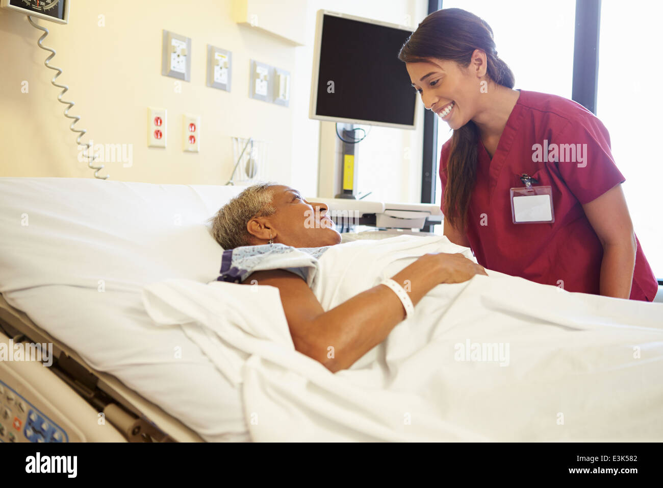 Infermiere parlando a Senior Donna nella stanza di ospedale Foto Stock