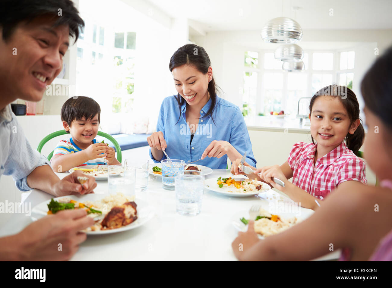 Famiglia asiatica seduta a tavola a mangiare mangiare insieme Foto Stock