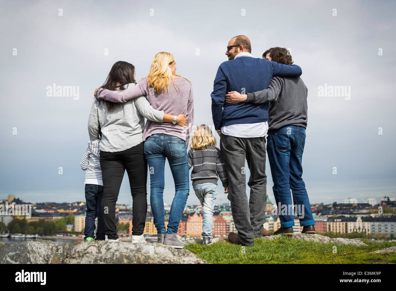 Lunghezza piena vista posteriore di famiglie di omosessuali in piedi sul lungolago Foto Stock