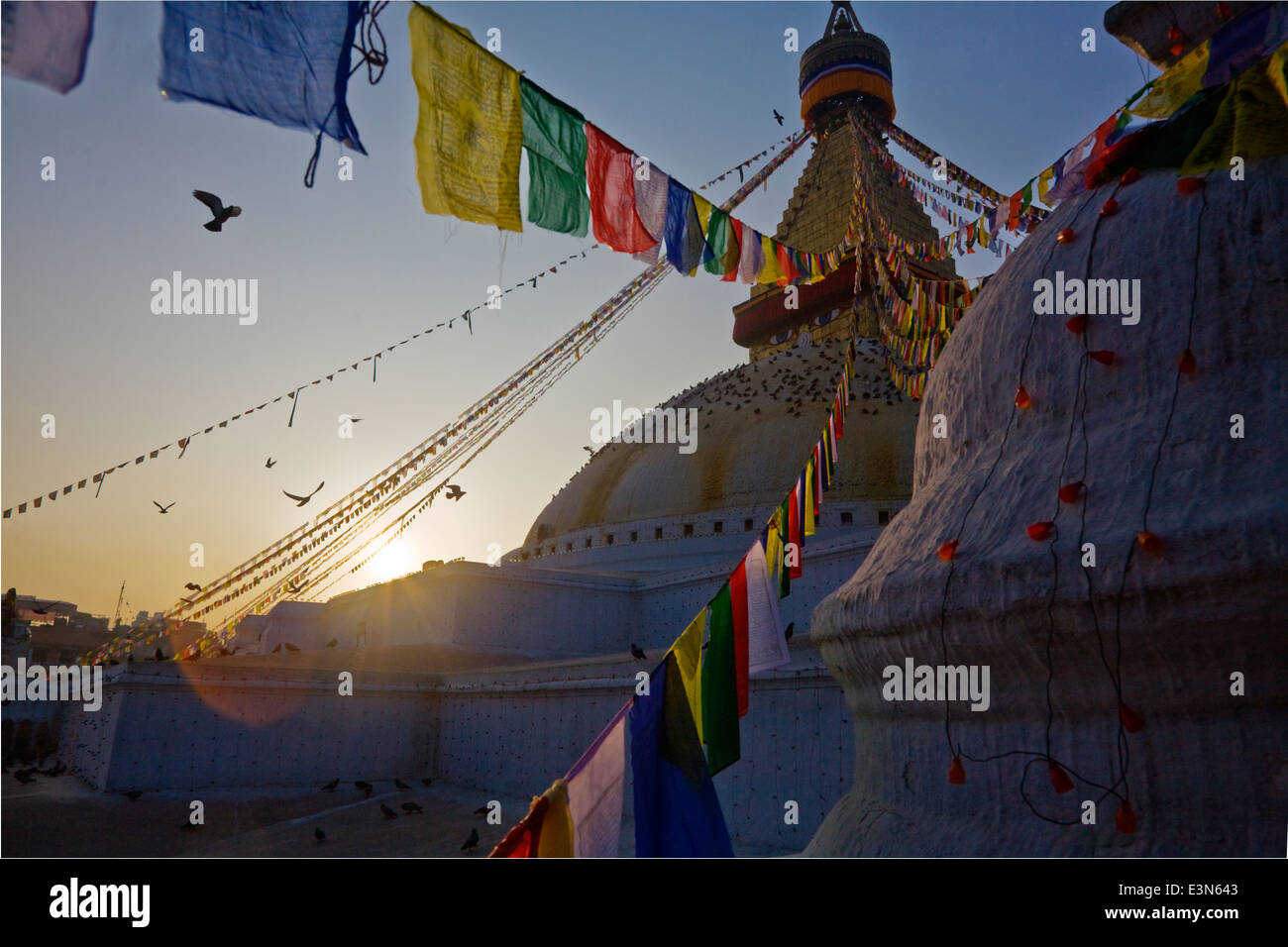 Preghiera tibetano bandiere soffiare la brezza a sunrise - BODHANATH STUPA, Kathmandu, Nepal Foto Stock