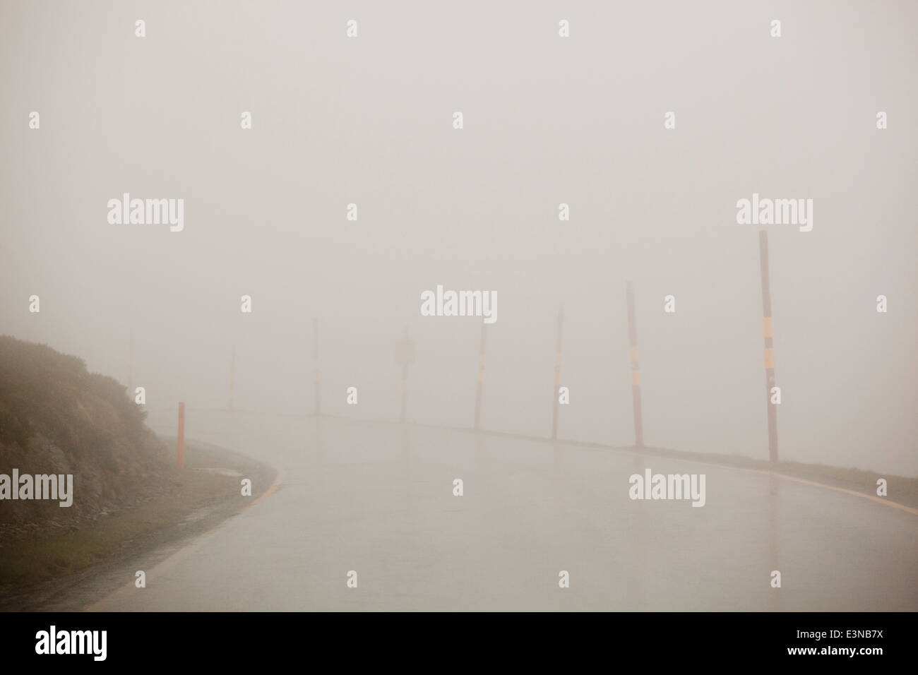 Svuotare strada coperta di nebbia contro il cielo chiaro Foto Stock