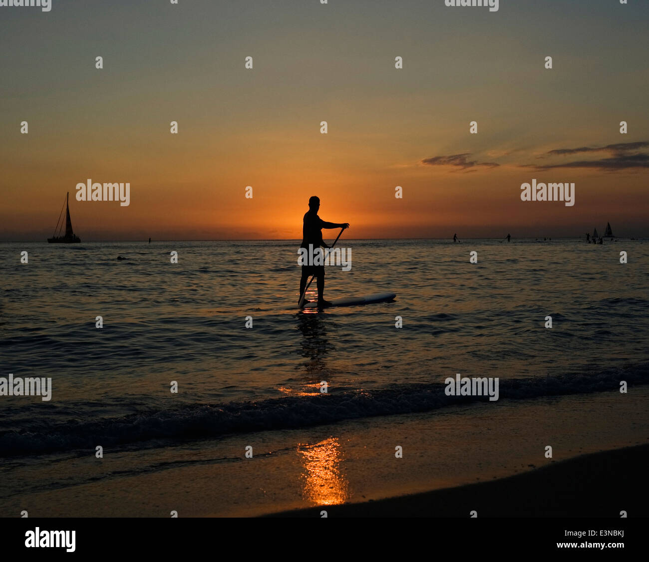 Stagliano uomo su stand up paddle board durante il tramonto Foto Stock