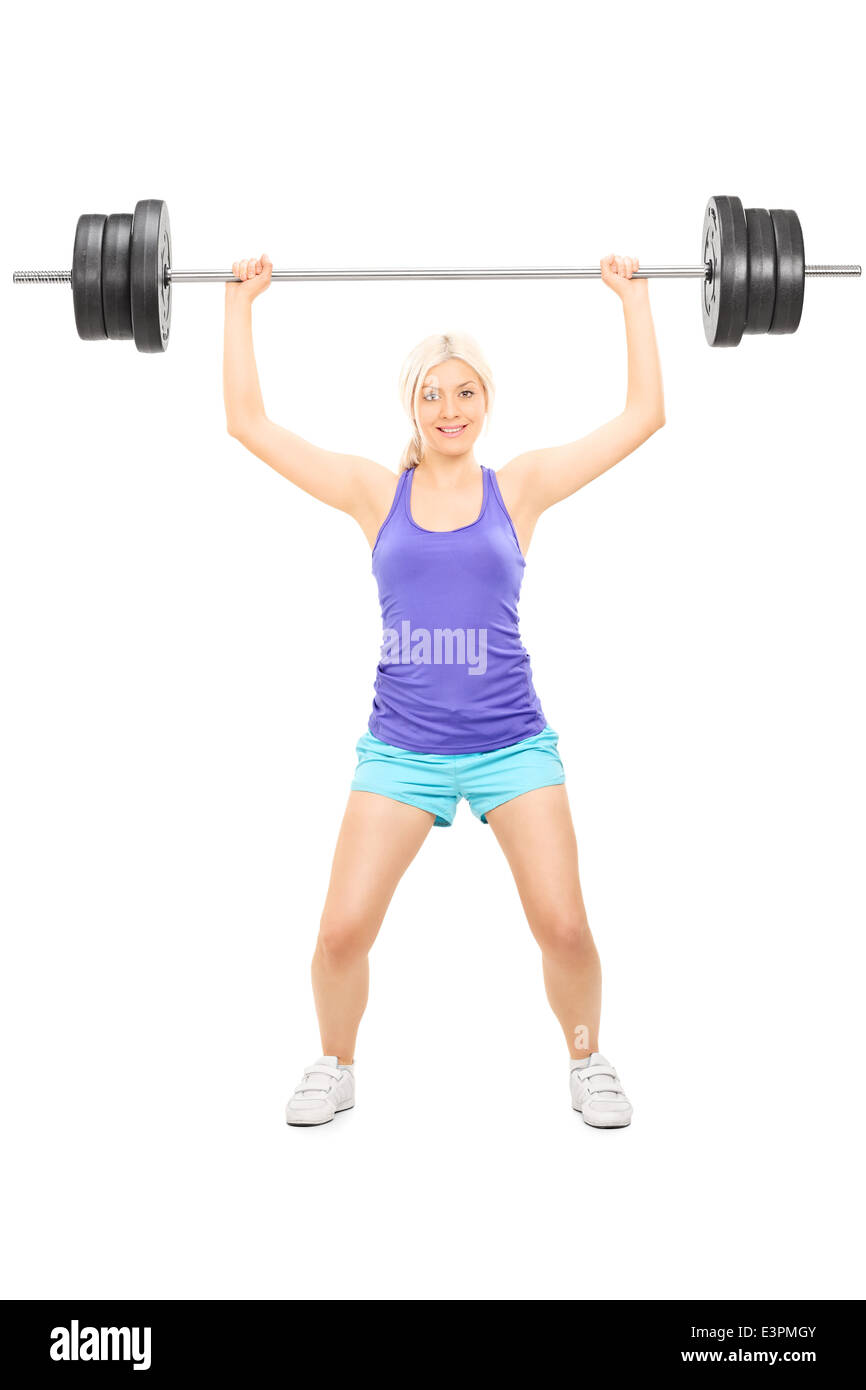 A piena lunghezza Ritratto di una bionda atleta femminile sollevando una pesante barbell Foto Stock