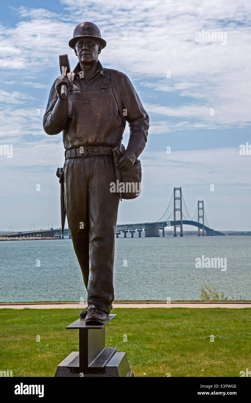 San Ignace, Michigan - Una statua di un ironworker è un monumento per i cinque operai uccisi nel costruire il ponte Mackinac. Foto Stock