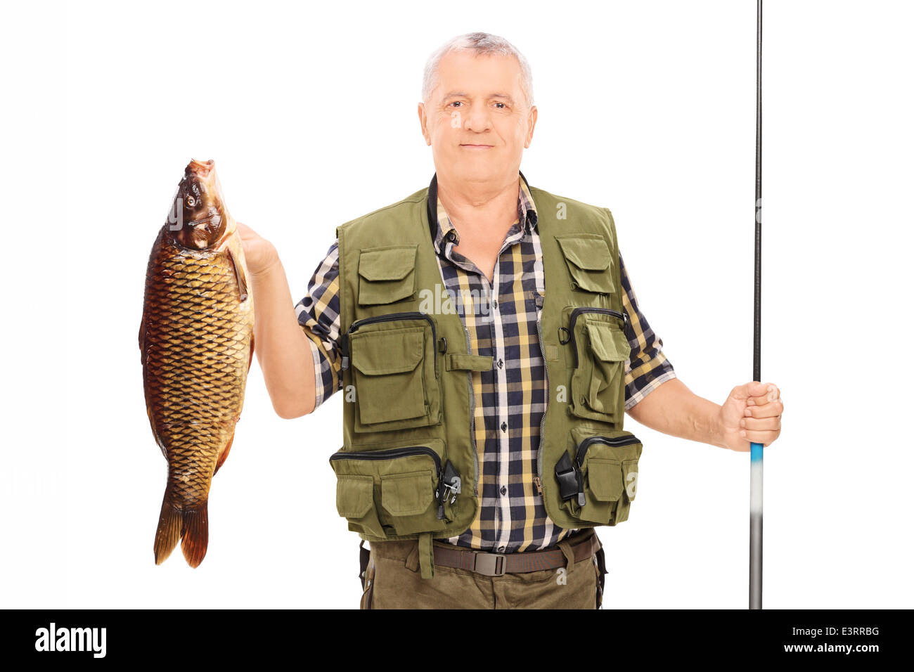 Fisherman tenendo un pesce e una canna da pesca Foto Stock