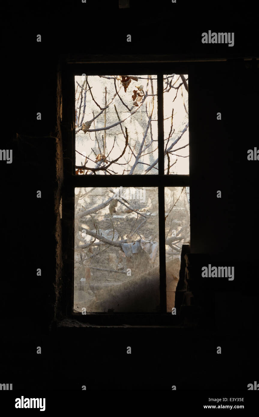 Polveroso del telaio della finestra nella stanza buia di una casa abbandonata. Foto Stock