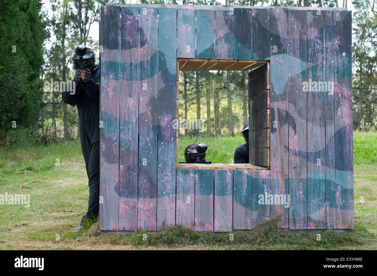 Sfera di vernice concorrenti tenendo il coperchio dietro un rifugio in legno Foto Stock