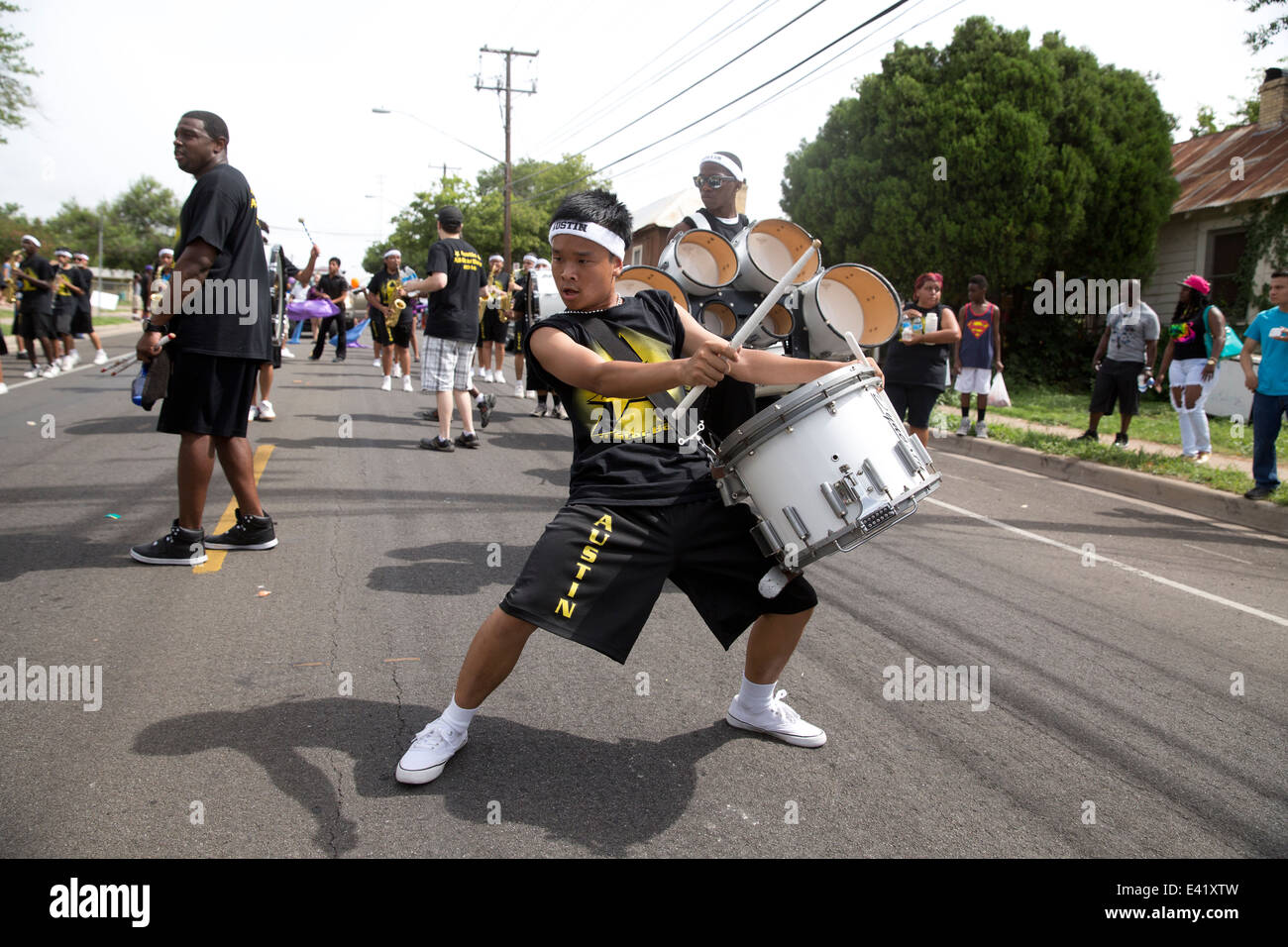 Asian maschio teen suona il tamburo con la banda di marcia durante una sfilata Juneteicesima ad Austin, Texas Foto Stock