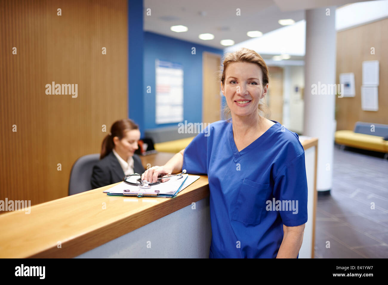 L'infermiera in piedi in ospedale in sala d'attesa Foto Stock