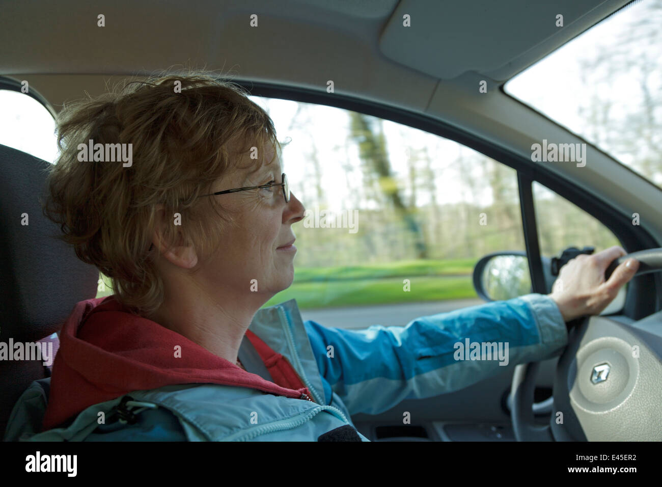 Una donna alla guida di una macchina Foto Stock