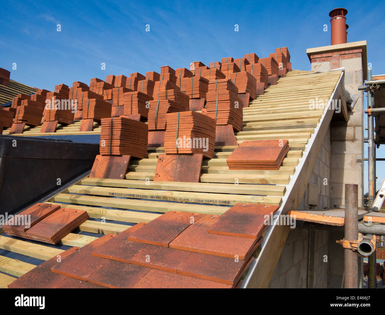 Auto casa Costruzione, costruzione tetto, mattonelle di terracotta impilati in fasci su listelli pronto per essere prevista Foto Stock